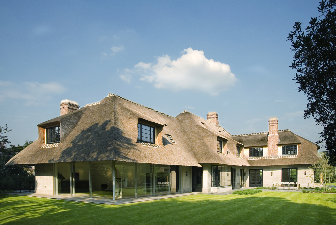 an historic building renovation with a thatched roof
